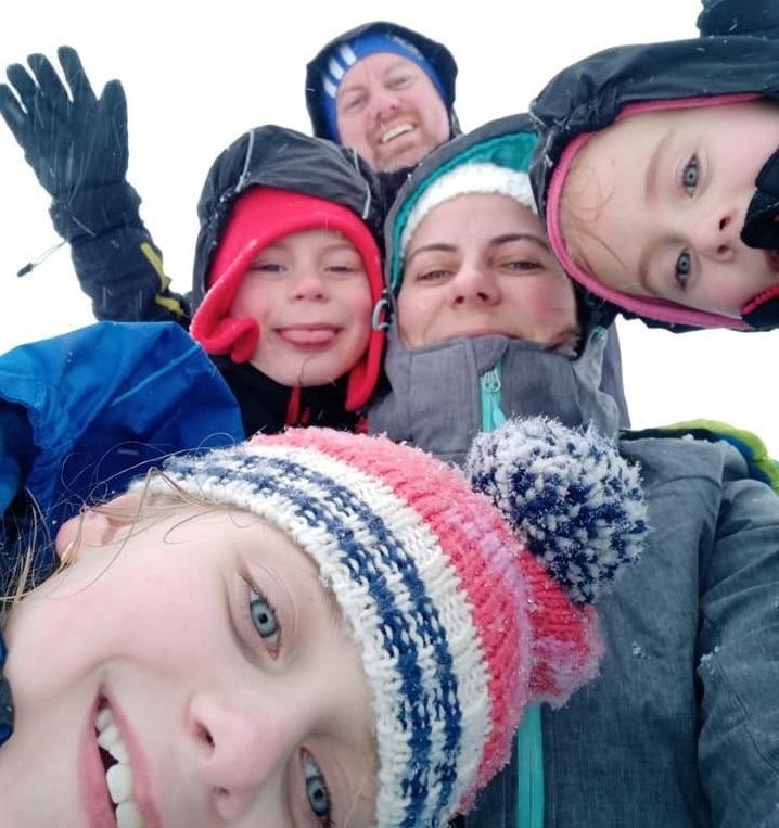 The Williams family smiling in the snow